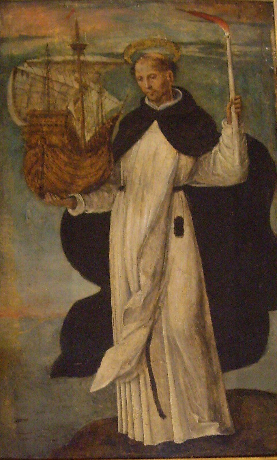 Pintura de san Telmo con hábito dominico y aureola, sosteniendo un barco y una vela encendida