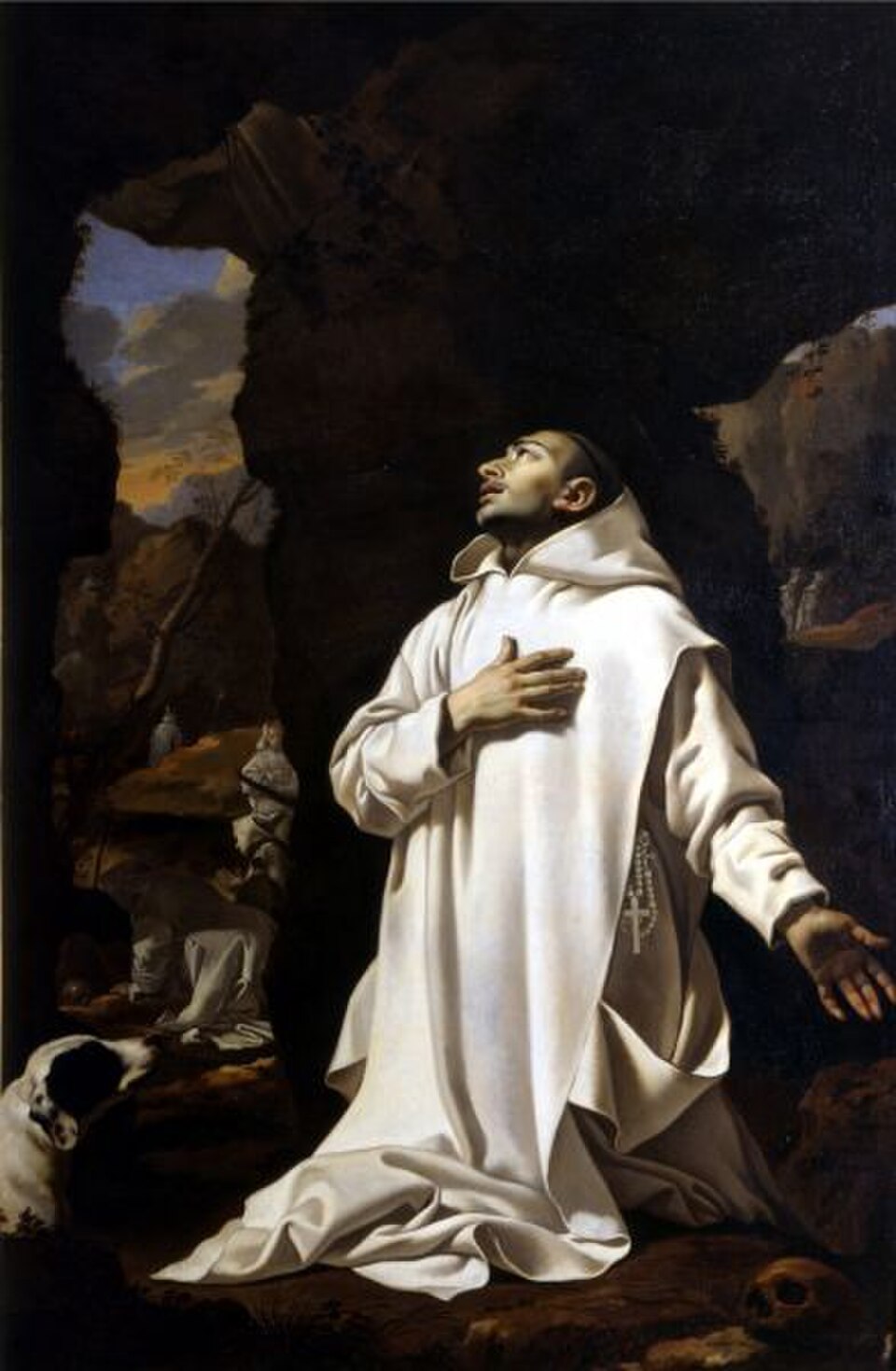 Pintura de san Bruno arrodillado con hábito blanco cartujo, mano en el pecho y mirada al cielo en una gruta