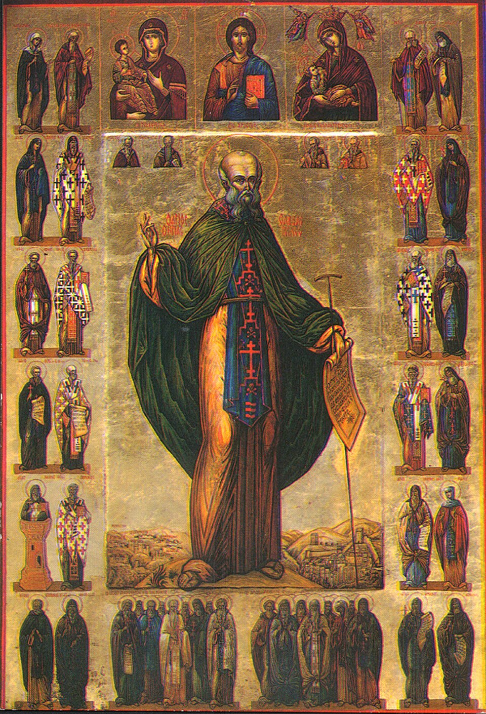 Icono de san Sabas con manto verde, larga barba, bastón y un pergamino, rodeado de pequeñas figuras de santos